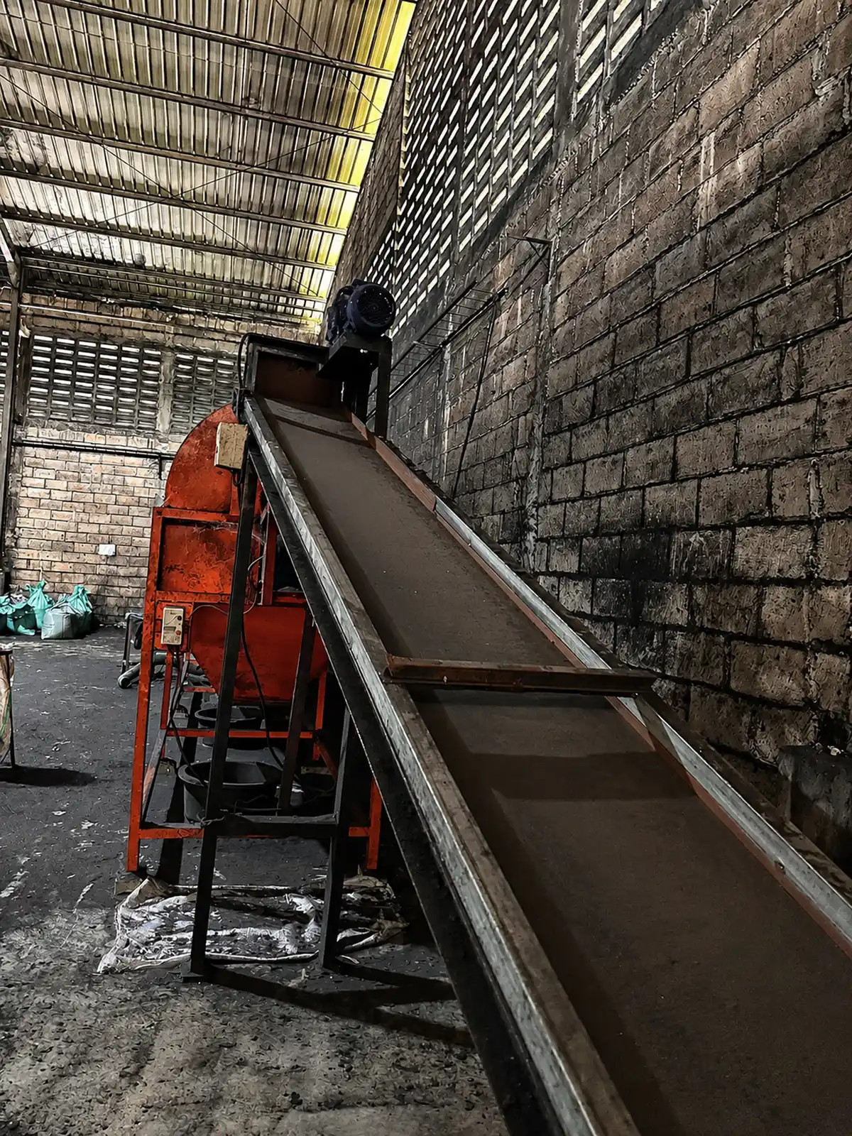 Raw material conveyor in coconut charcoal briquettes factory